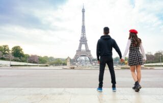 cheerful happy couple in love visiting Paris city centre and Eiffel Tower